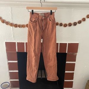 Terracotta orange pants.two tiny grease marks that could probably b removed.